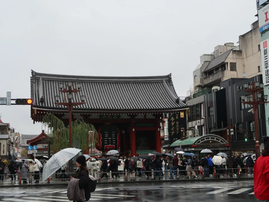 Rainy day at Senso-ji Temple in Asakusa with tourists walking under umbrellas